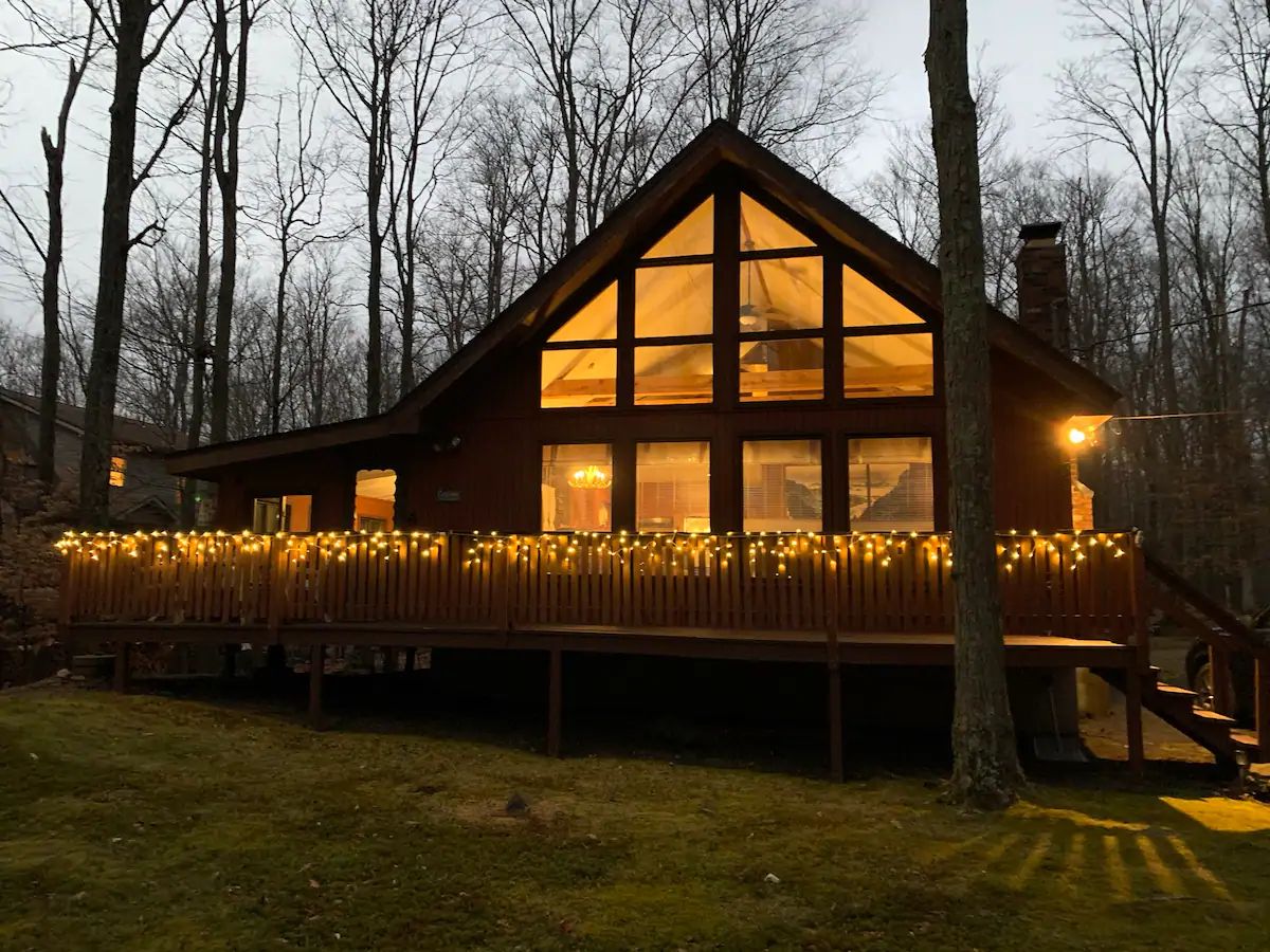 Mountain Lodge exterior with string lights at dusk